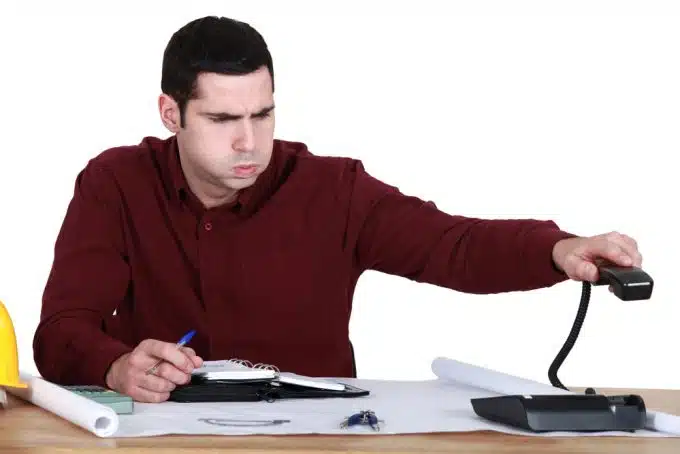 Stressed man hanging up the phone