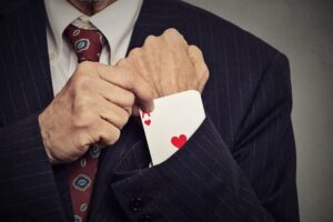 cropped image man hand pulling out a hidden ace from sleeve cropped image man hand pulling out a hidden ace from sleeve