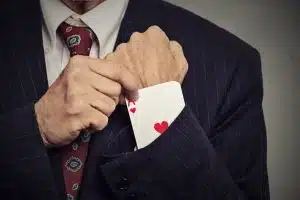 cropped image man hand pulling out a hidden ace from sleeve