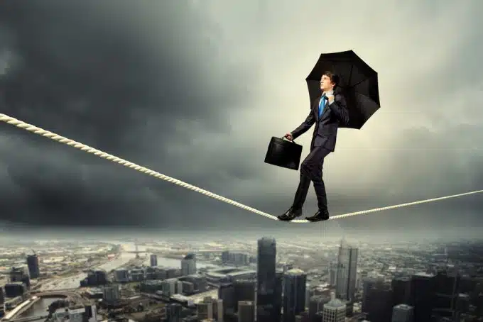 Businessman balancing on rope