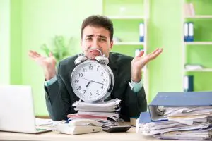 Businessman angry with excessive work sitting in the office