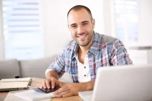 Man working on laptop computer from home