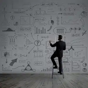 Businessman writing imaginary text on stairs. Black background w