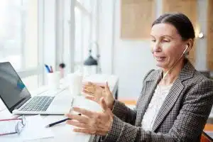 Smiling Mature Woman Working in Cafe