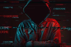 Cybercrime concept with faceless hooded male person Cybersecurity