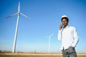 Engineer checks Wind Turbine system with a tablet. Alternative Energy. Wind farm. Clean renewable energy technologies. Wind power plants