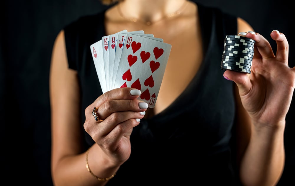 beautiful woman playing poker holding casino chips and dollars and enjoying winning. beautiful woman playing poker holding casino chips and dollars and enjoying winning.
