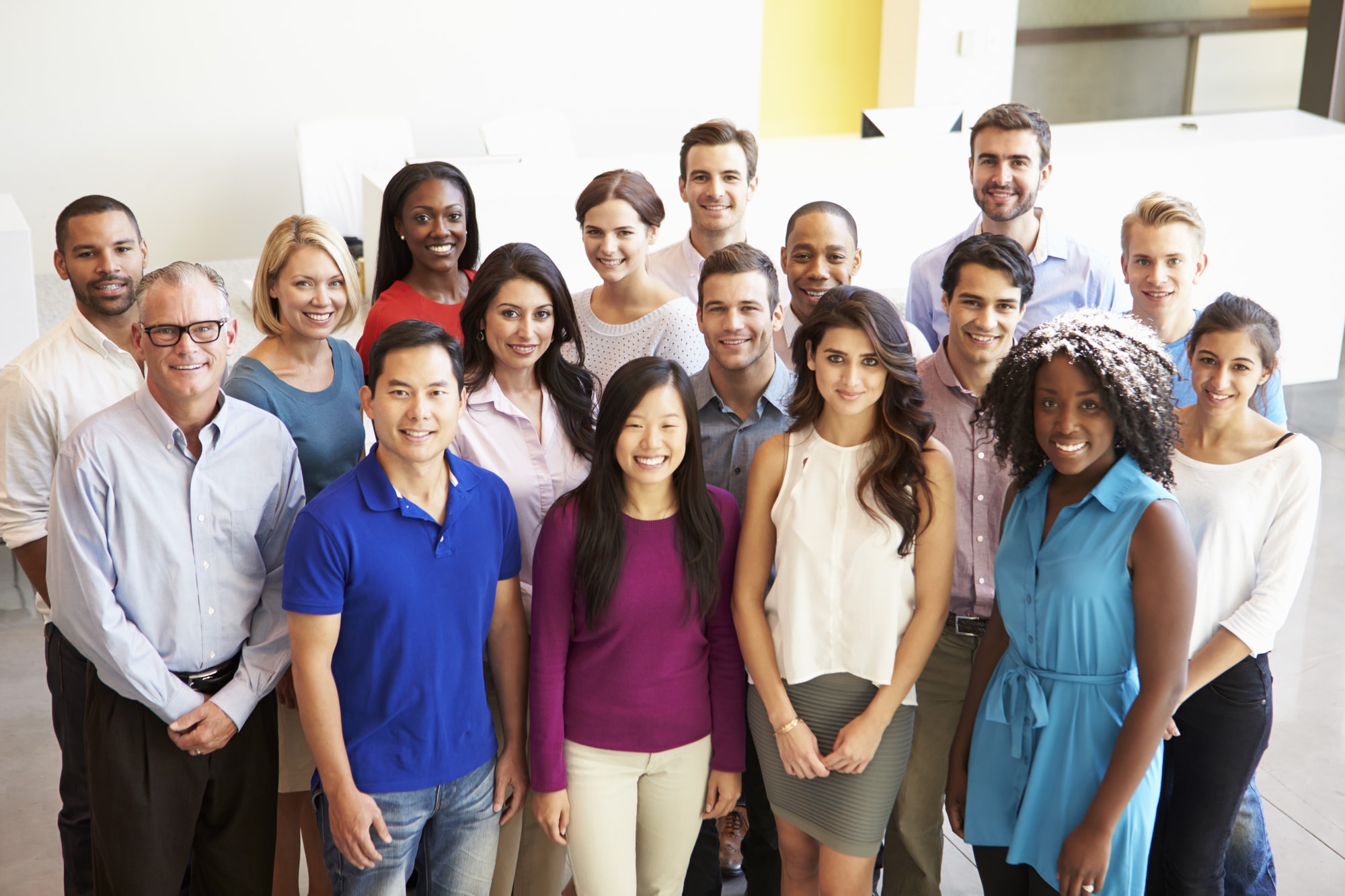Portrait Of Multi-Cultural Office Staff Standing In Lobby