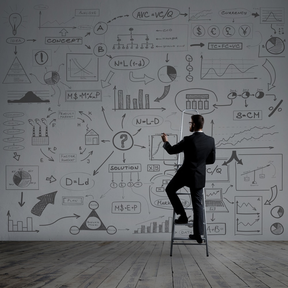 Businessman writing imaginary text on stairs. Black background w Businessman writing imaginary text on stairs. Black background w